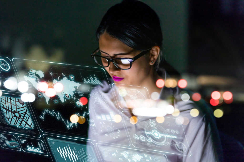 SOLUTIONS METRIX photo, woman engineer looking at various information in screen of futuristic interface.